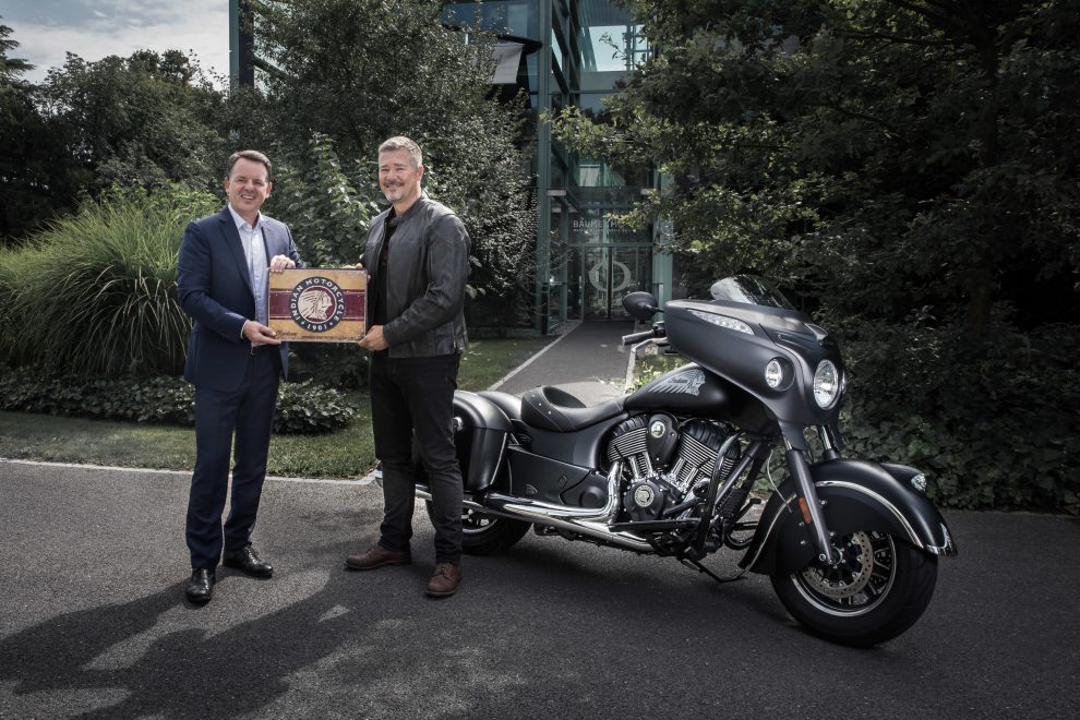 1502641705_alain-zimmermann-and-grant-bester Alain Zimmermann, CEO of Baume & Mercier, with Grant Bester,Vice President, Indian Motorcycle EMEA, celebrate their partnership in front of a Chieftain Dark Horse® motorbike.