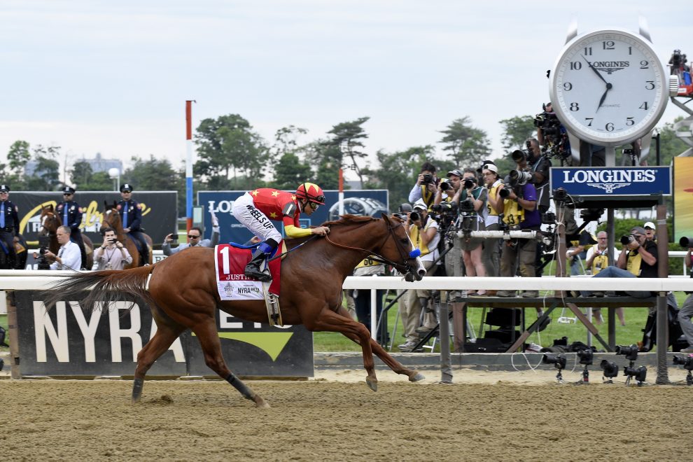 Justify, ridden by Mike Smith, wins the Triple Crown and the 150th running of the Belmont Stakes, Saturday, June 9, 2018, at Belmont Park in Elmont, NY. Longines, the Swiss watchmaker known for its elegant timepieces, is the Official Timekeeper and Watch of the 150th running of the Belmont Stakes. (Photo by Diane Bondareff/AP Images for Longines)