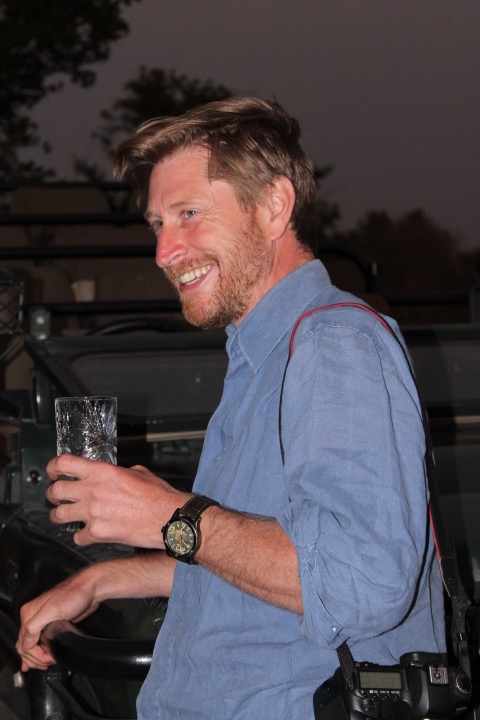 Photographer Adrian Fisk enjoying sundowners during a night drive