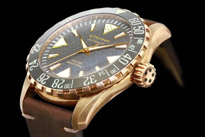 The dial of the Eterna KonTiki Bronze Manufacture watch is jet-black granite pattern and features luminescent markers for easy underwater reading. 