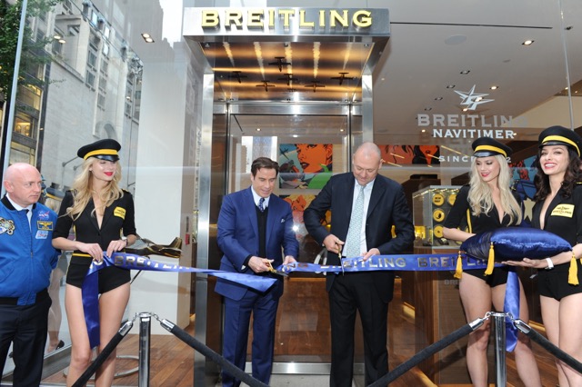 Breitling President Thierry Prissert and Travolta cut the ribbon 