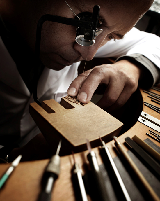 Master engraver Dominique Vuez works on the tiny componens. 