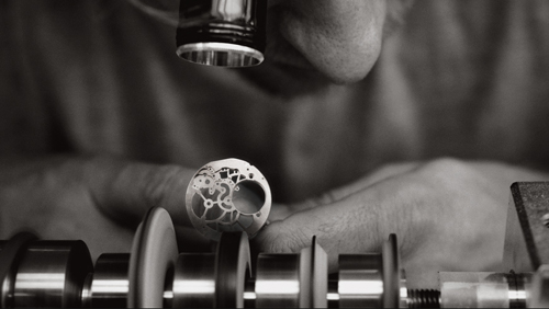 Examining the hand bevel work on an Audemars Piguet mainplate. 