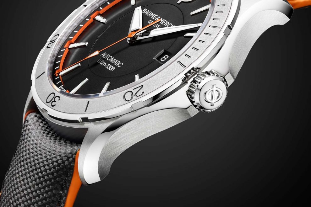 Each Baume & Mercier Clifton Club Collection watch features bold orange accents. Each Baume & Mercier Clifton Club Collection watch features bold orange accents.